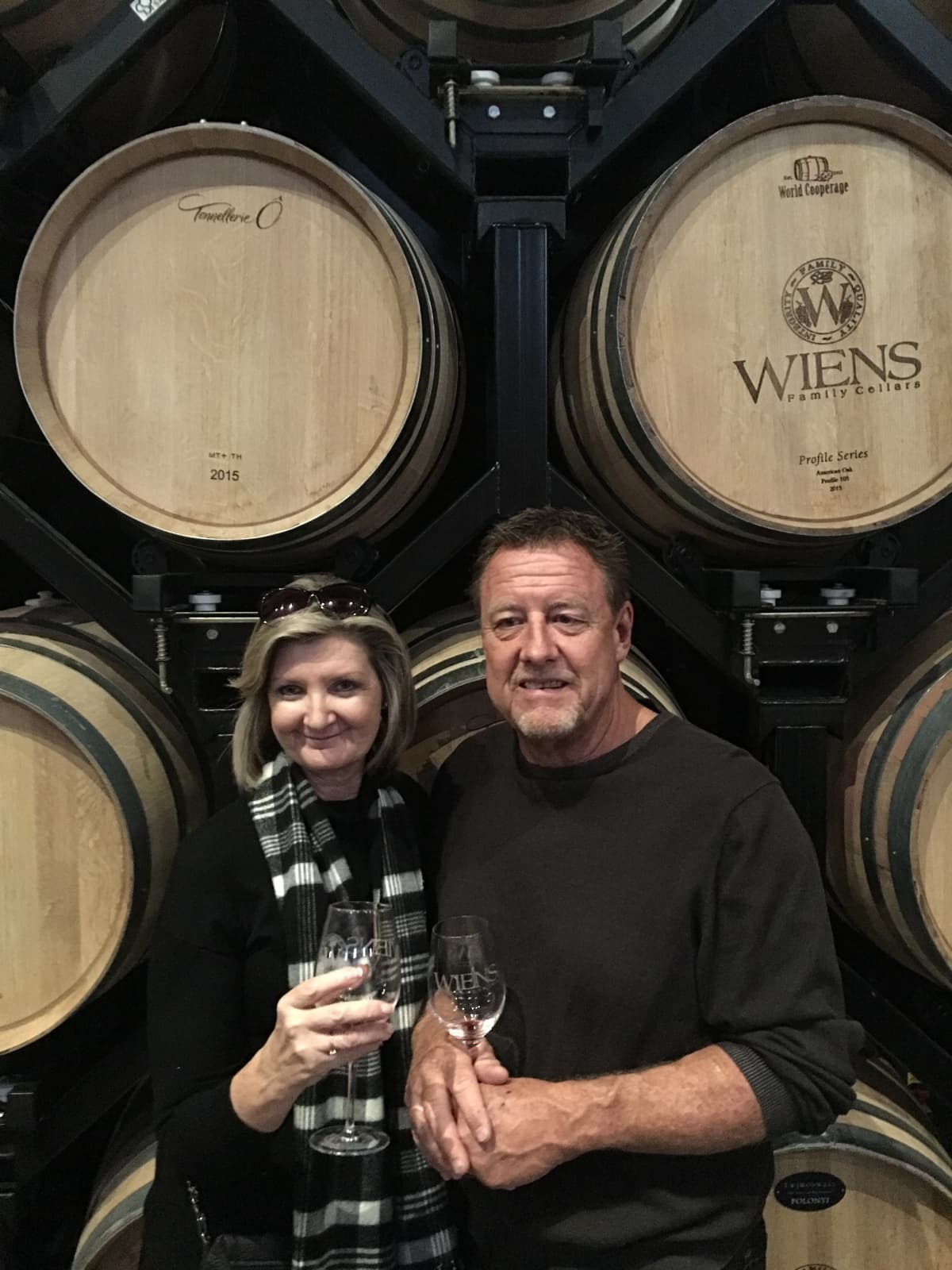 Don and Diane Greiner tasting wine in the barrel room